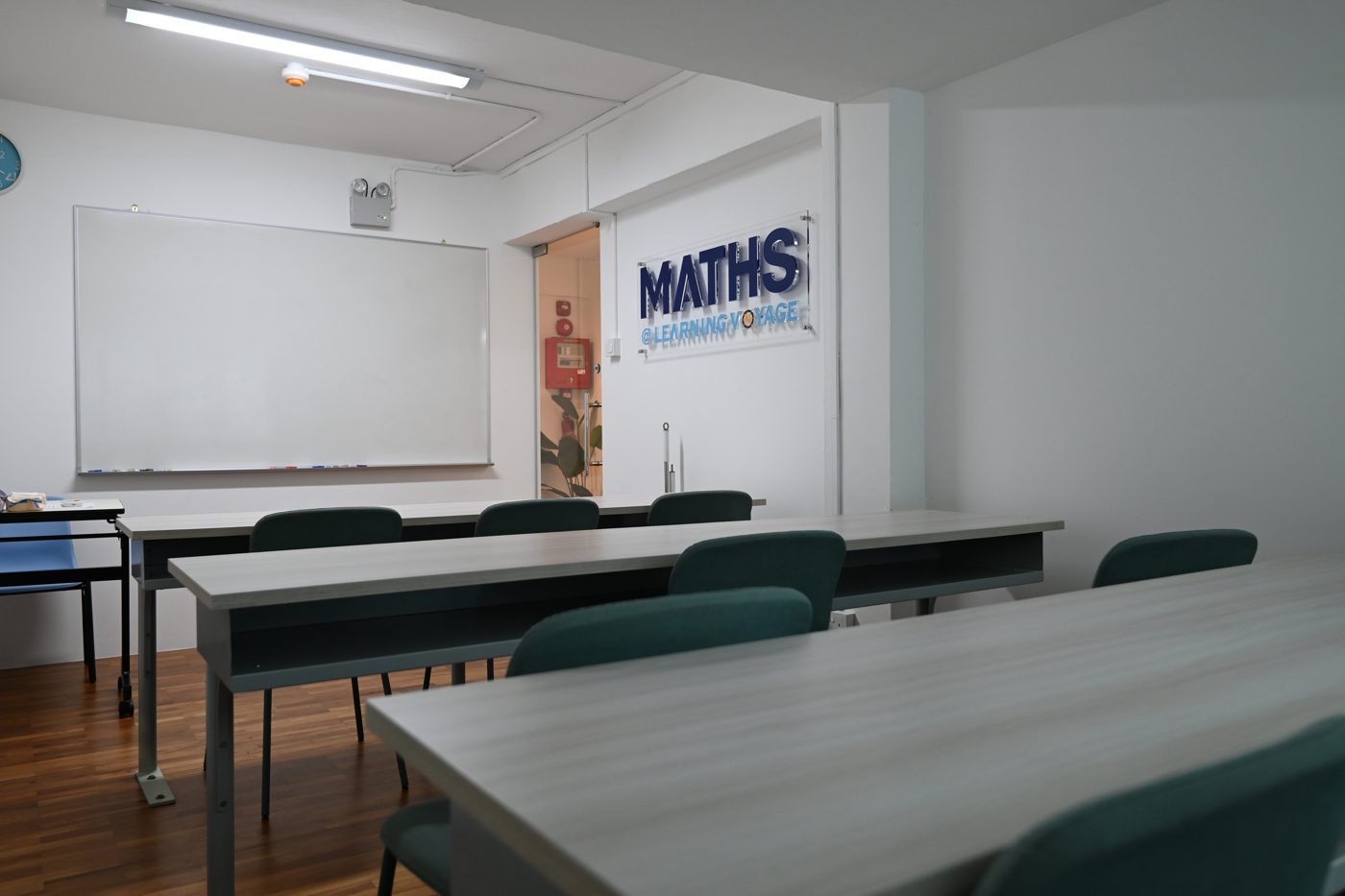 Maths classroom with the centre name on the wall