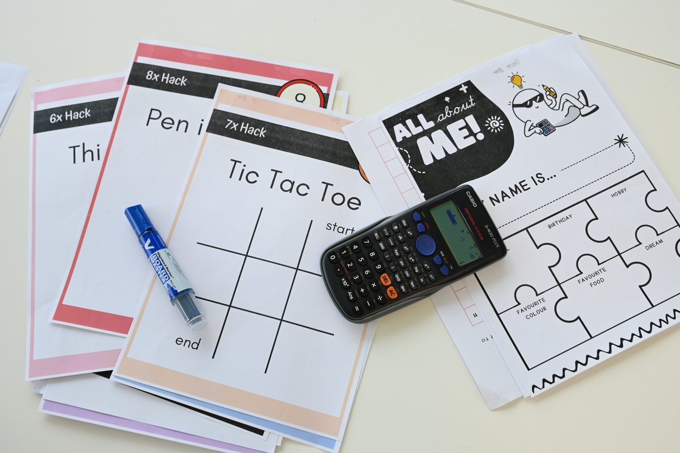 Study cheatsheets and a calculator on a desk